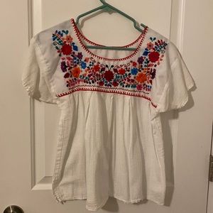 White flowy blouse with fun floral detail